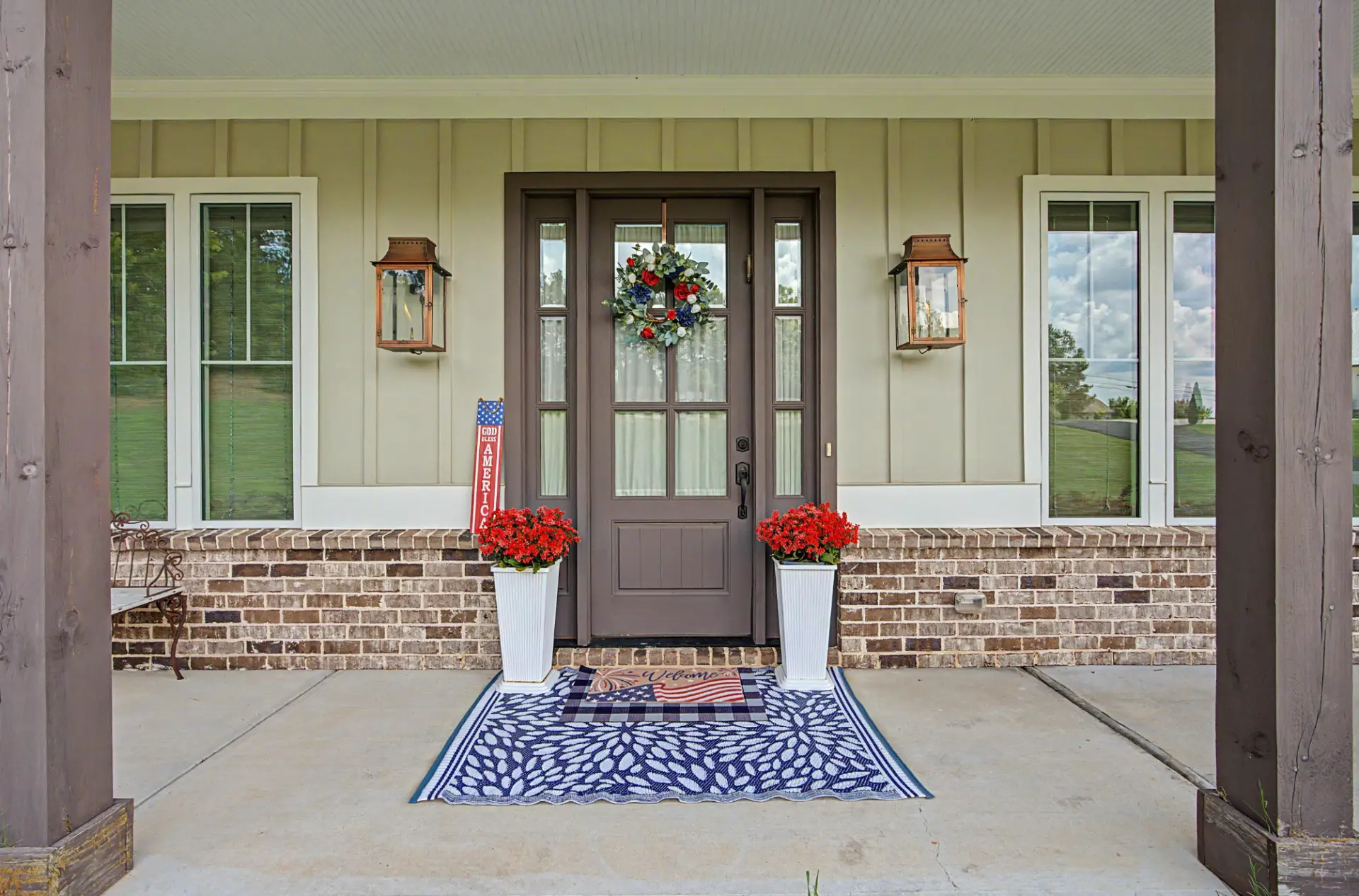 Front entry with glass-panel door, copper lanterns, and brick detail