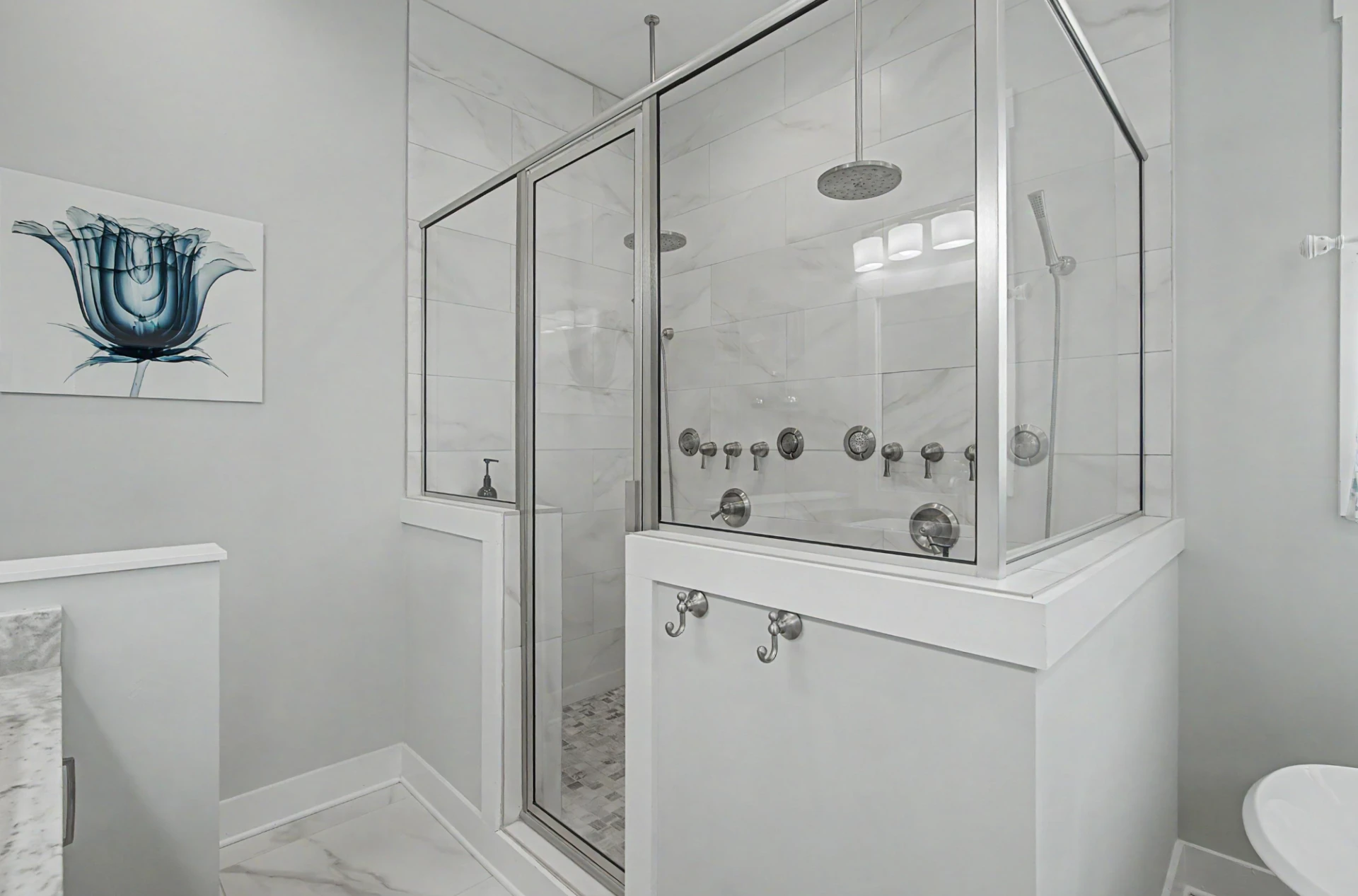 Walk-in glass shower with rain heads and body sprays